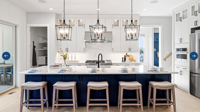 22 Sienna Ct, Dix Hills, NY 11746 - kitchen with an inviting chandelier, light countertops, wall oven, and wall chimney exhaust hood