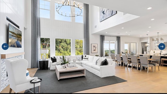 22 Sienna Ct, Dix Hills, NY 11746 - living room featuring a high ceiling, an inviting chandelier, and wood finished floors