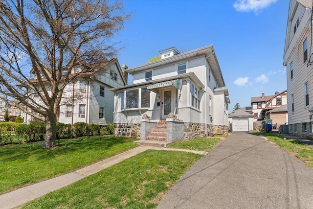 118 N Regent St, Port Chester, NY 10573 - traditional style home featuring stucco siding, an outbuilding, a residential view, a detached garage, and a front lawn