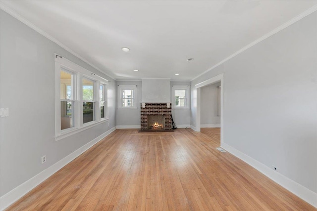 118 N Regent St, Port Chester, NY 10573 - unfurnished living room with ornamental molding, a fireplace, light wood-style flooring, and baseboards