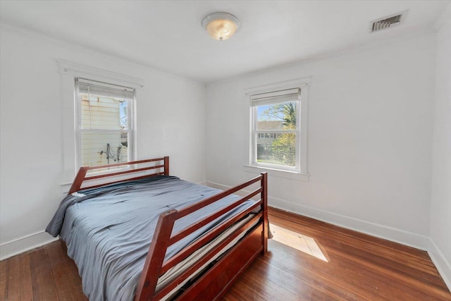 118 N Regent St, Port Chester, NY 10573 - bedroom featuring visible vents, hardwood / wood-style floors, ornamental molding, and baseboards