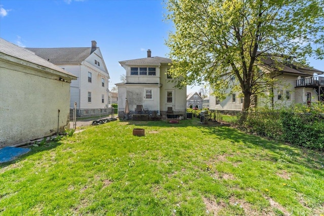 118 N Regent St, Port Chester, NY 10573 - rear view of property with a yard, stucco siding, a fenced backyard, and a chimney