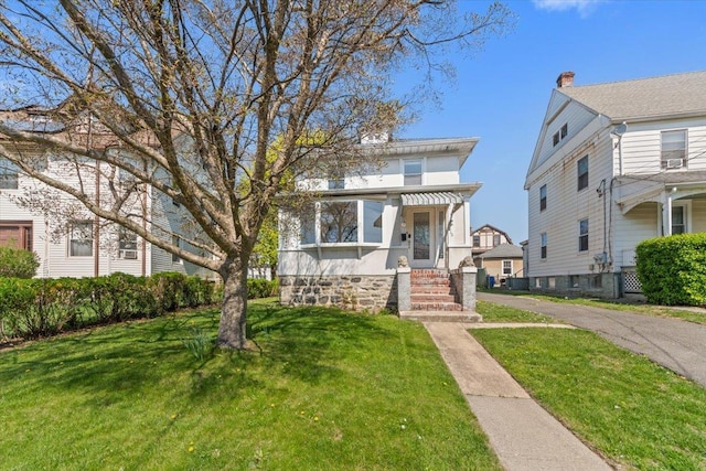 118 N Regent St, Port Chester, NY 10573 - american foursquare style home featuring a front lawn
