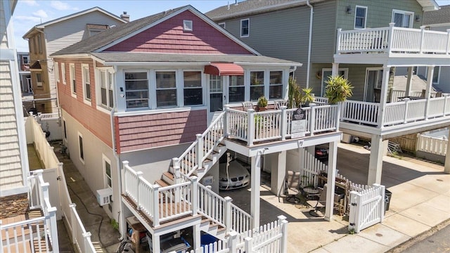 72 Nebraska St, Long Beach, NY 11561 - rear view of property with stairway, a fenced backyard, a shingled roof, and a patio