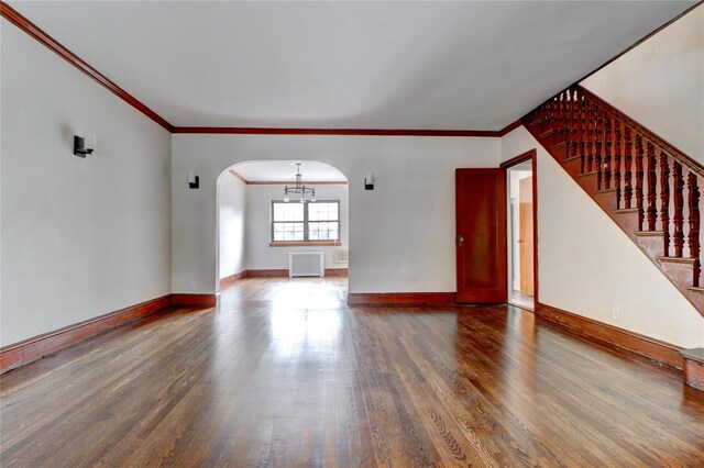 48-42 64th St, Woodside, NY 11377 - unfurnished living room with ornamental molding, arched walkways, wood finished floors, and baseboards