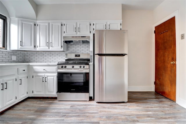 48-42 64th St, Woodside, NY 11377 - kitchen with white cabinetry, decorative backsplash, appliances with stainless steel finishes, light countertops, and under cabinet range hood