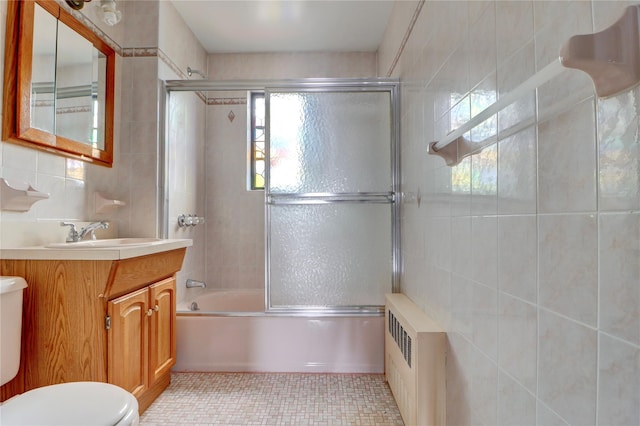 48-42 64th St, Woodside, NY 11377 - bathroom with radiator, enclosed tub / shower combo, toilet, tile walls, and tile patterned flooring