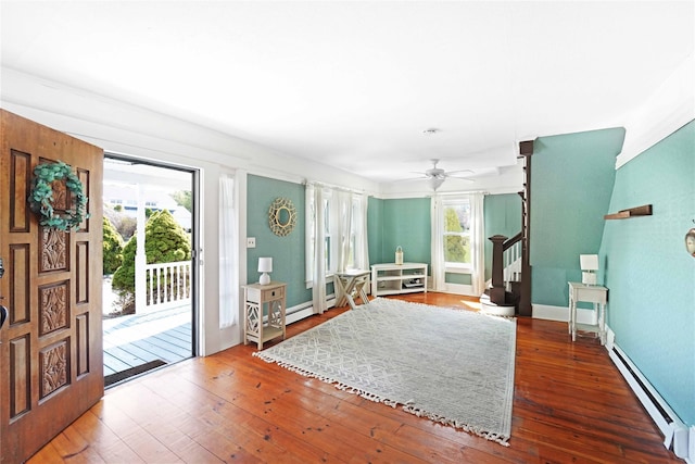 48 Watchogue Ave, East Moriches, NY 11940 - entryway with stairs, a baseboard radiator, hardwood / wood-style floors, baseboards, and a ceiling fan