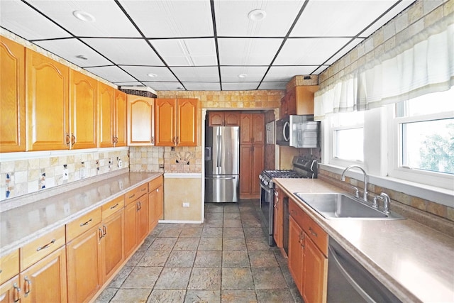 48 Watchogue Ave, East Moriches, NY 11940 - kitchen with a sink, stone finish flooring, stainless steel appliances, light countertops, and backsplash