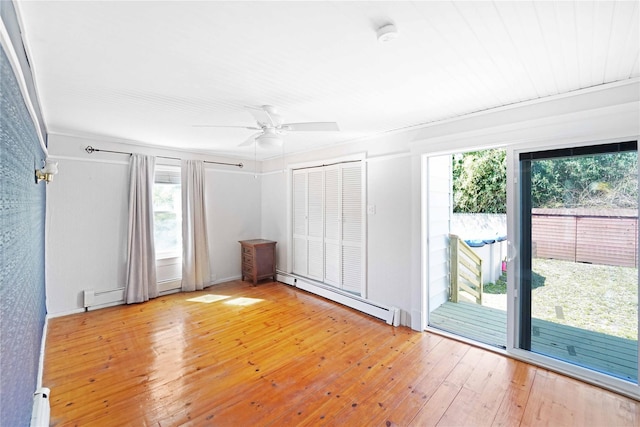 48 Watchogue Ave, East Moriches, NY 11940 - spare room with baseboard heating, ceiling fan, a wealth of natural light, and light wood-style flooring