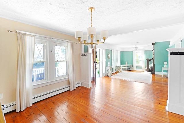 48 Watchogue Ave, East Moriches, NY 11940 - unfurnished dining area featuring stairway, ceiling fan with notable chandelier, a textured ceiling, and light wood-style flooring