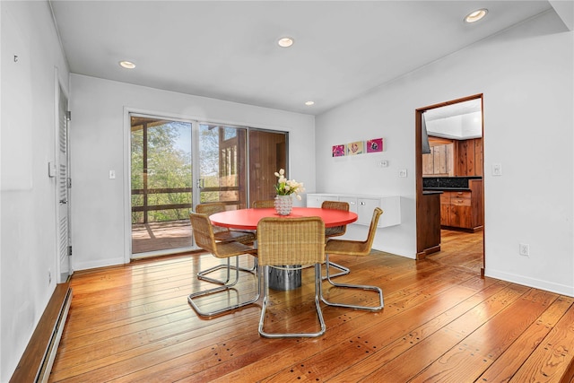 dining room with baseboard heating, light wood-style flooring, recessed lighting, and baseboards