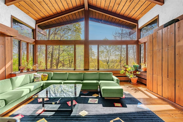 sunroom / solarium featuring a deck, hardwood / wood-style floors, wood ceiling, and wood walls