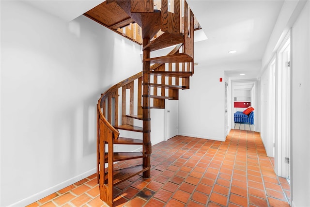 stairs with baseboards and recessed lighting