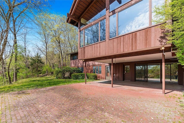 view of side of home with a lawn