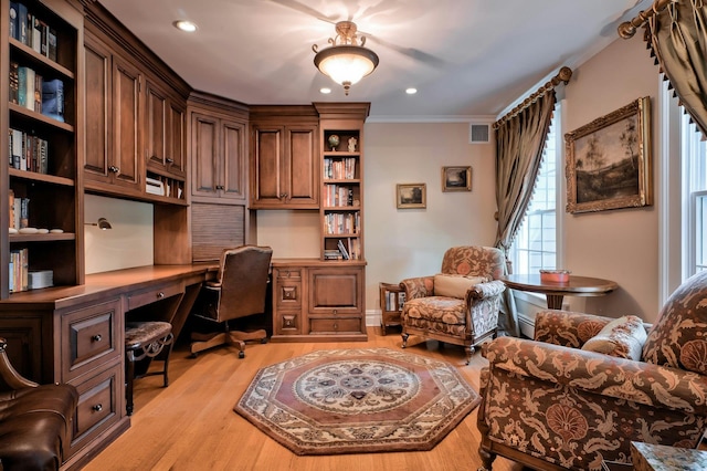 office featuring recessed lighting, light wood-style flooring, built in study area, visible vents, and crown molding