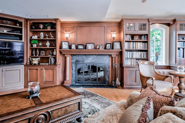living area with wood finished floors and a fireplace
