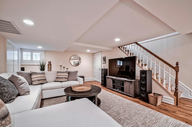 living area featuring recessed lighting, stairway, visible vents, baseboards, and wood finished floors