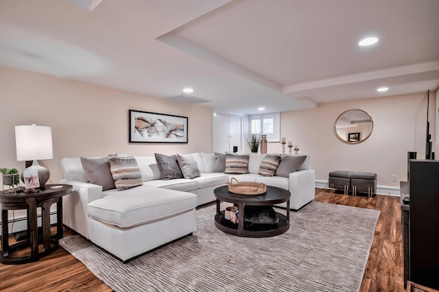 living area featuring visible vents, recessed lighting, wood finished floors, and a baseboard heating unit