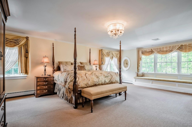 bedroom with a notable chandelier, a baseboard heating unit, carpet floors, and multiple windows