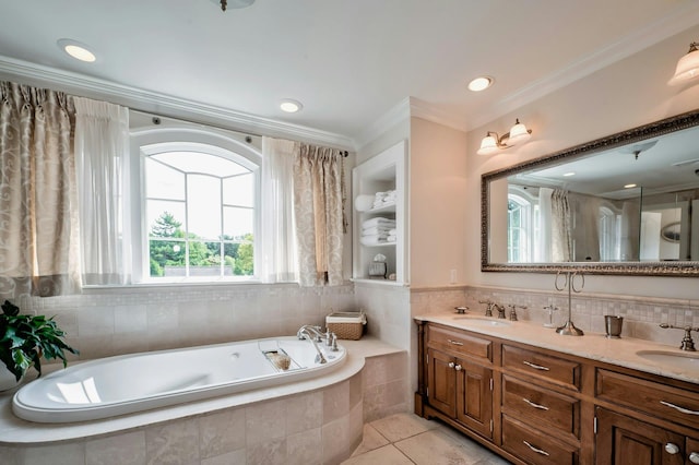 full bathroom with crown molding, a garden tub, a sink, and tile patterned floors