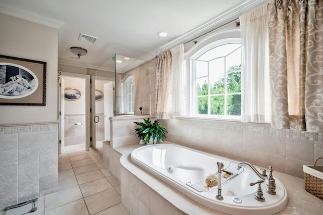 bathroom featuring tile walls, a shower stall, crown molding, visible vents, and a jetted tub
