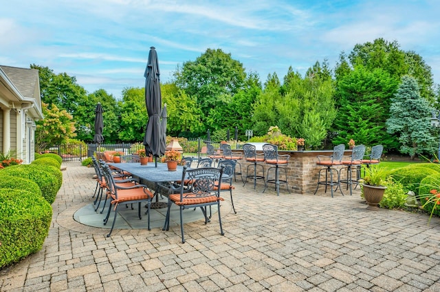 view of patio / terrace featuring fence and outdoor dry bar