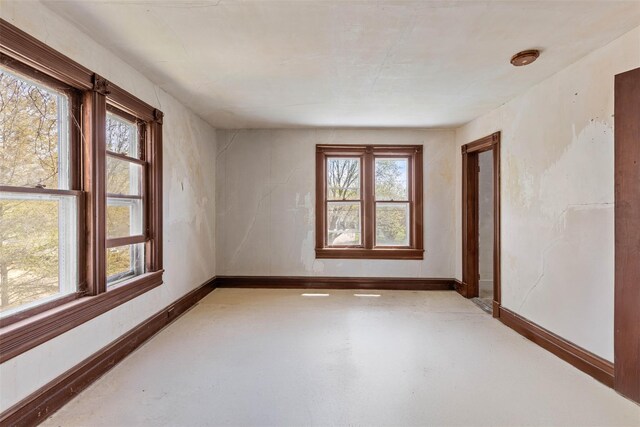 26705 Main Rd, Cutchogue, NY 11935 - empty room with plenty of natural light, finished concrete flooring, and baseboards
