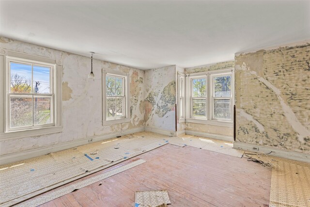 26705 Main Rd, Cutchogue, NY 11935 - spare room featuring plenty of natural light, wood finished floors, and baseboards