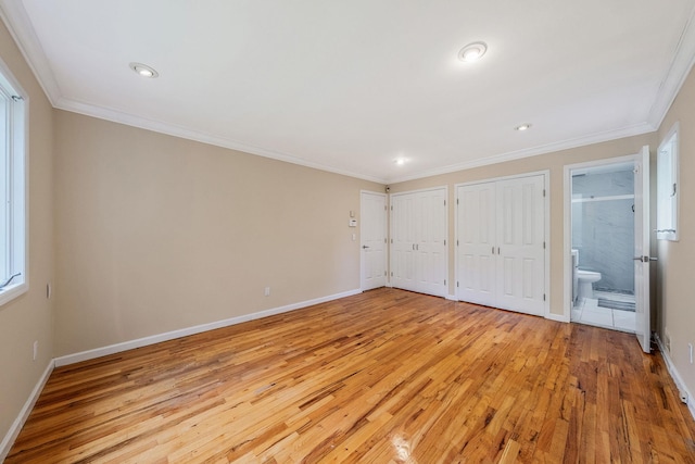 57 Seward Dr, Dix Hills, NY 11746 - unfurnished bedroom with light wood-style floors, ornamental molding, baseboards, and two closets