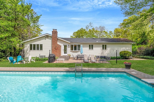 57 Seward Dr, Dix Hills, NY 11746 - back of property with a yard, an outdoor pool, a patio area, and an outdoor fire pit