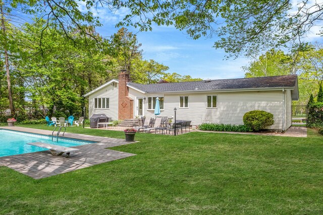 57 Seward Dr, Dix Hills, NY 11746 - back of house with an outdoor pool, entry steps, a chimney, a patio area, and a yard