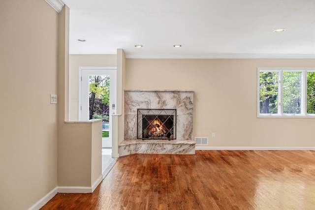 57 Seward Dr, Dix Hills, NY 11746 - unfurnished living room with baseboards, wood finished floors, a high end fireplace, visible vents, and ornamental molding
