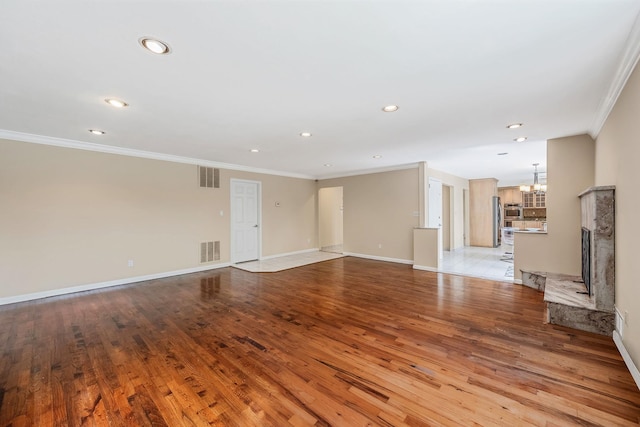 57 Seward Dr, Dix Hills, NY 11746 - unfurnished living room with visible vents, light wood finished floors, and crown molding