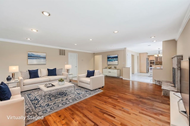 57 Seward Dr, Dix Hills, NY 11746 - living area featuring ornamental molding, visible vents, recessed lighting, light wood finished floors, and an inviting chandelier