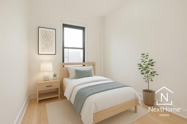 21-58 35th St Unit 5G, Astoria, NY 11105 - bedroom with light wood-type flooring and baseboards