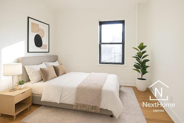 21-58 35th St Unit 5G, Astoria, NY 11105 - bedroom with wood finished floors and baseboards