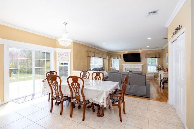 dining area featuring recessed lighting, a fireplace, light tile patterned floors, visible vents, and ornamental molding