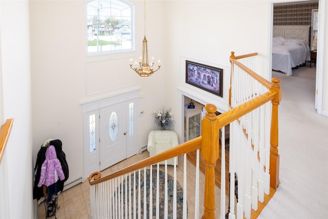 tiled entrance foyer featuring a notable chandelier and a baseboard radiator