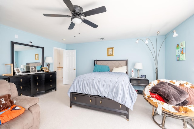 carpeted bedroom with a ceiling fan and visible vents