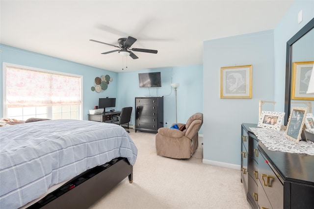 bedroom with ceiling fan, baseboards, and light carpet