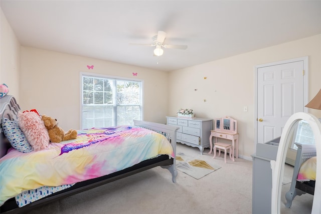 bedroom with a ceiling fan and light carpet