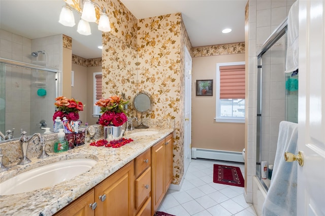 bathroom featuring baseboard heating, wallpapered walls, tile patterned flooring, and a sink
