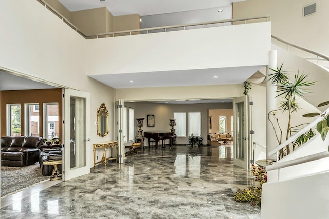 9 Dock Ln, Kings Point, NY 11024 - building lobby with stairs, a high ceiling, and recessed lighting