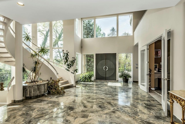 9 Dock Ln, Kings Point, NY 11024 - entryway featuring healthy amount of natural light, stairs, marble tiled floors, a high ceiling, and recessed lighting