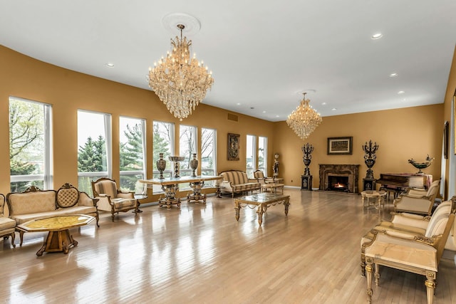 9 Dock Ln, Kings Point, NY 11024 - living area with a chandelier, a premium fireplace, light wood-style flooring, and recessed lighting
