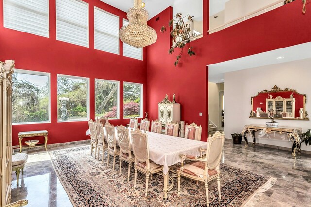 9 Dock Ln, Kings Point, NY 11024 - dining space with a towering ceiling, marble tiled floors, stairway, and a chandelier