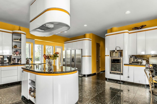 9 Dock Ln, Kings Point, NY 11024 - kitchen with open shelves, stainless steel fridge, dark countertops, a center island, and recessed lighting