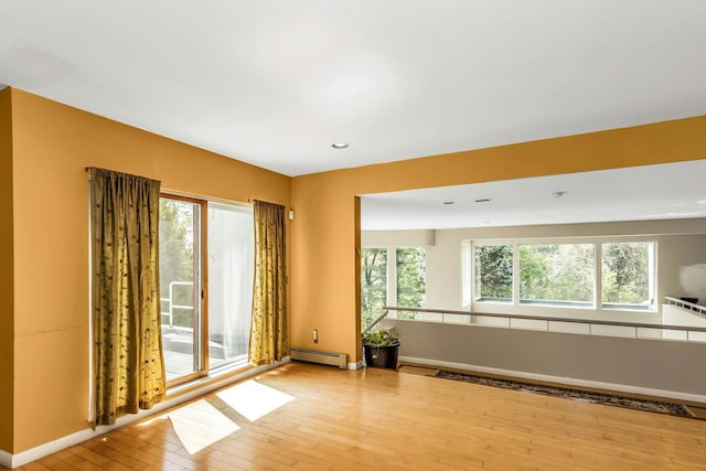 9 Dock Ln, Kings Point, NY 11024 - empty room featuring a baseboard radiator, hardwood / wood-style floors, baseboards, and recessed lighting