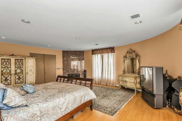 9 Dock Ln, Kings Point, NY 11024 - bedroom featuring light wood finished floors, a fireplace, and recessed lighting